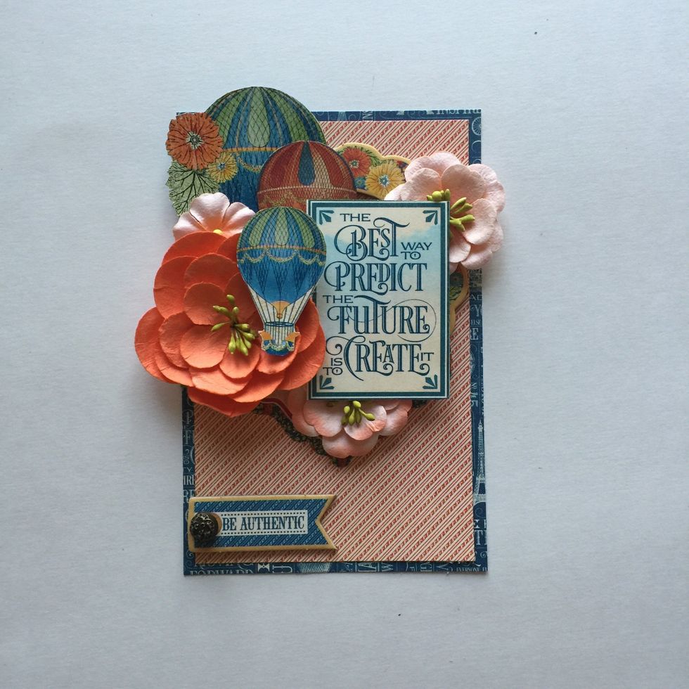 At the bottom left corner of card, add a chipboard banner from the Decorative Chipboard. (Optional: add a Graphic 45 Ornate Brad to the chipboard piece before adhering.)