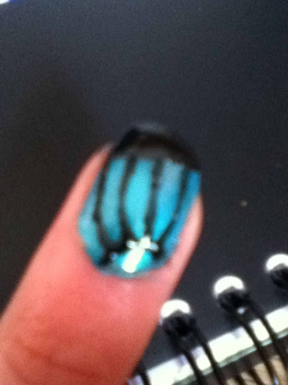 At the bottom right of the nail, paint a small arch and paint four thin lines coming of it that join the black at the top.