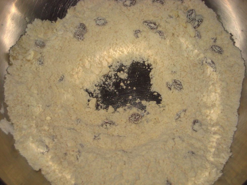 At the centre of the flour mix, make a well to add in the milk