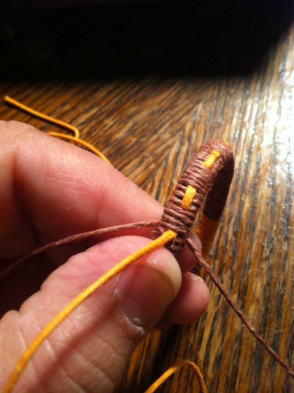 At the end you should have something like this. The left string in the picture is the string I wrapped with. The one to the right was the long "tail" that we left alone. Tie a knot with them.