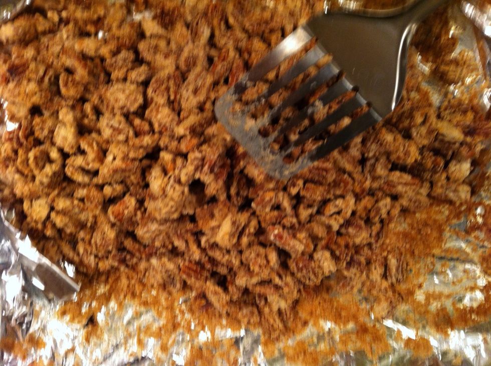 At the first 20 minute mark, carefully toss and fold the pecans. Careful not to tear the foil! Using a spatula, turn the pecans over and fluff them up. Put them back in for another 20.