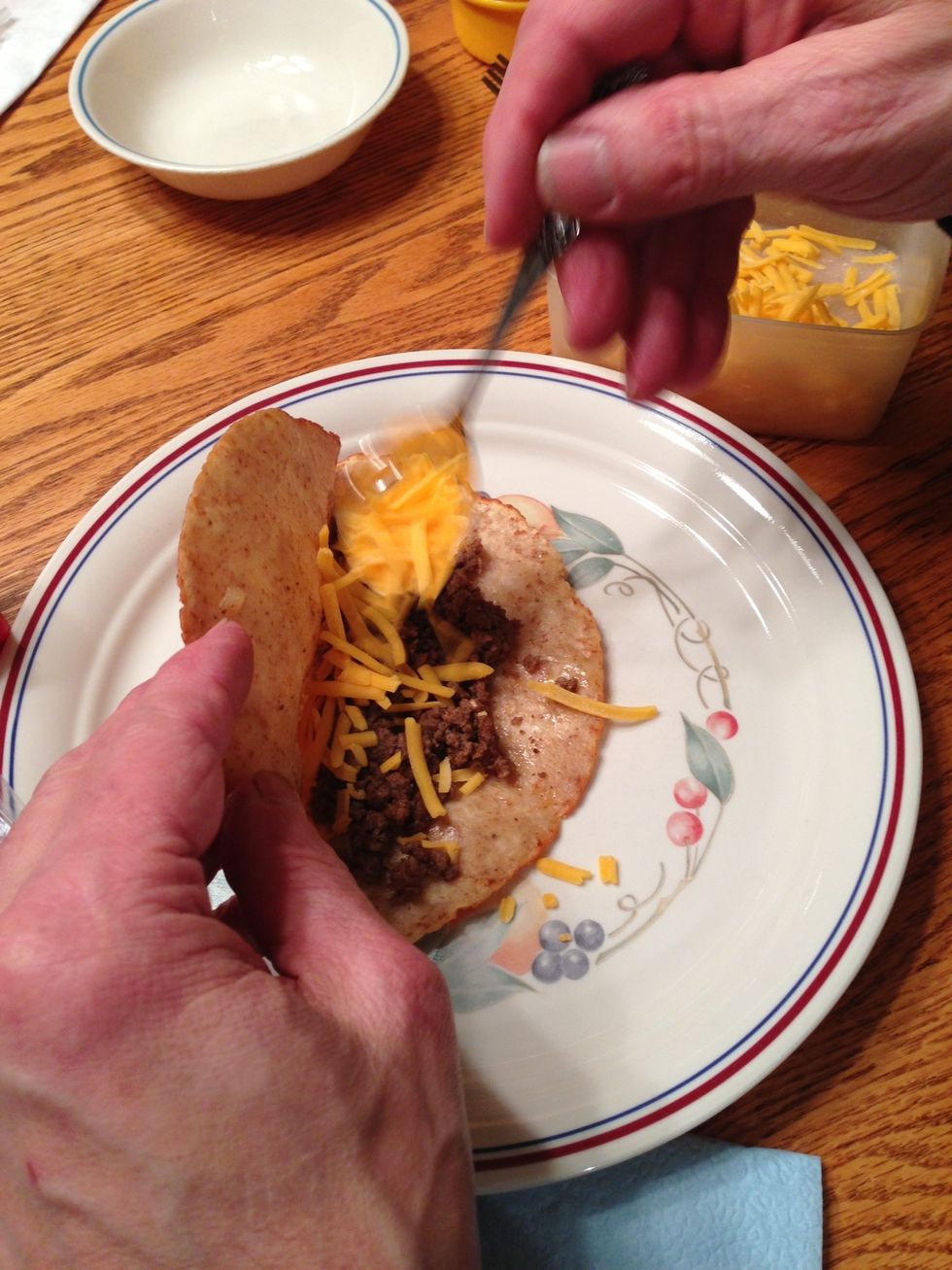 At the table just before eating, we spoon in shredded cheddar cheese and lettuce. You can also add diced fresh tomatoes, salsa, whatever.