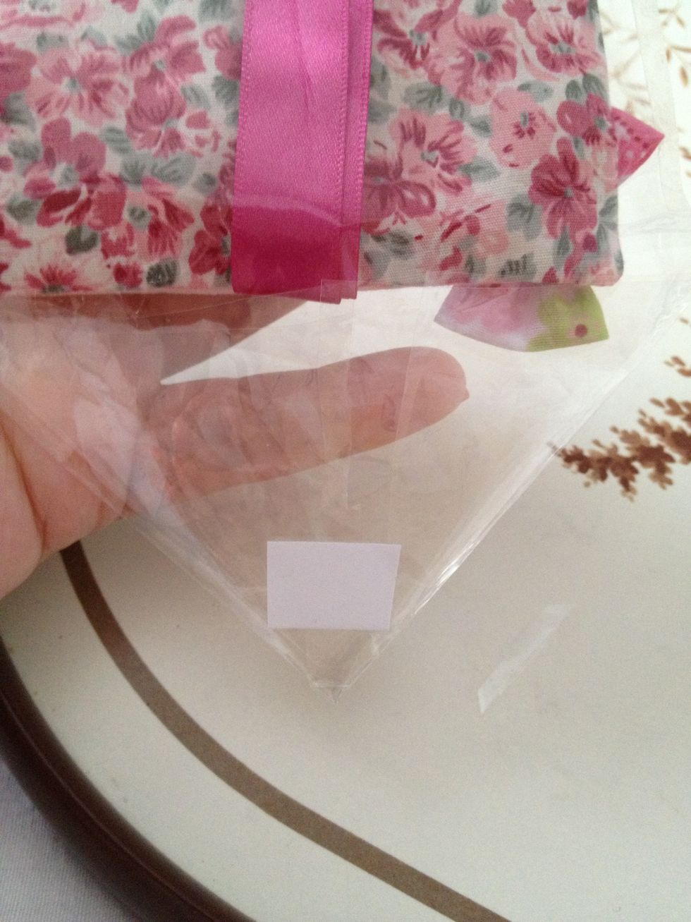 At the top fold into a point and place a small piece of tape