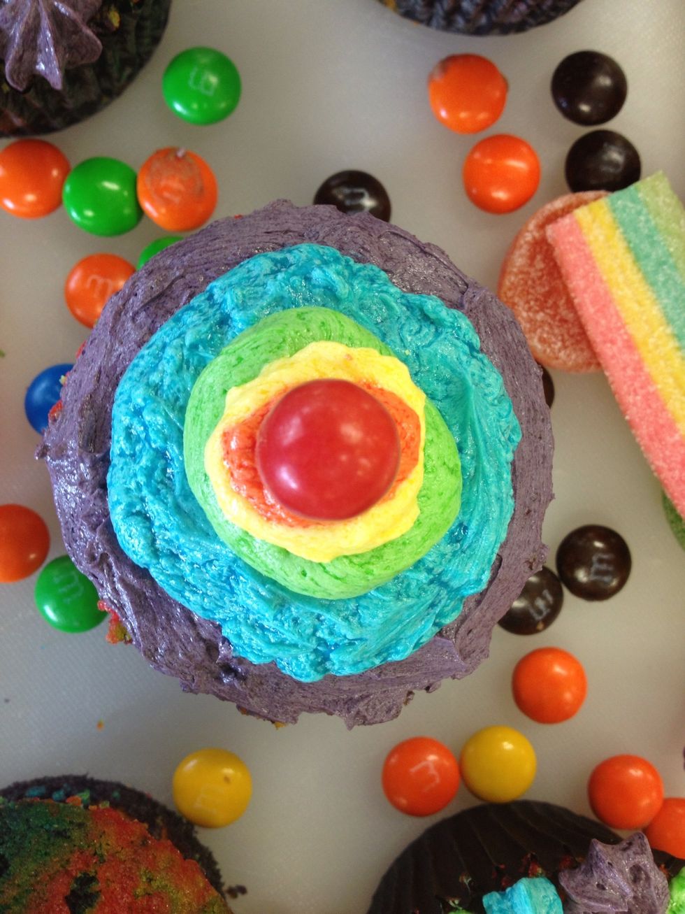 At the top of the cupcake place a red Jaffa ontop of the orange icing.