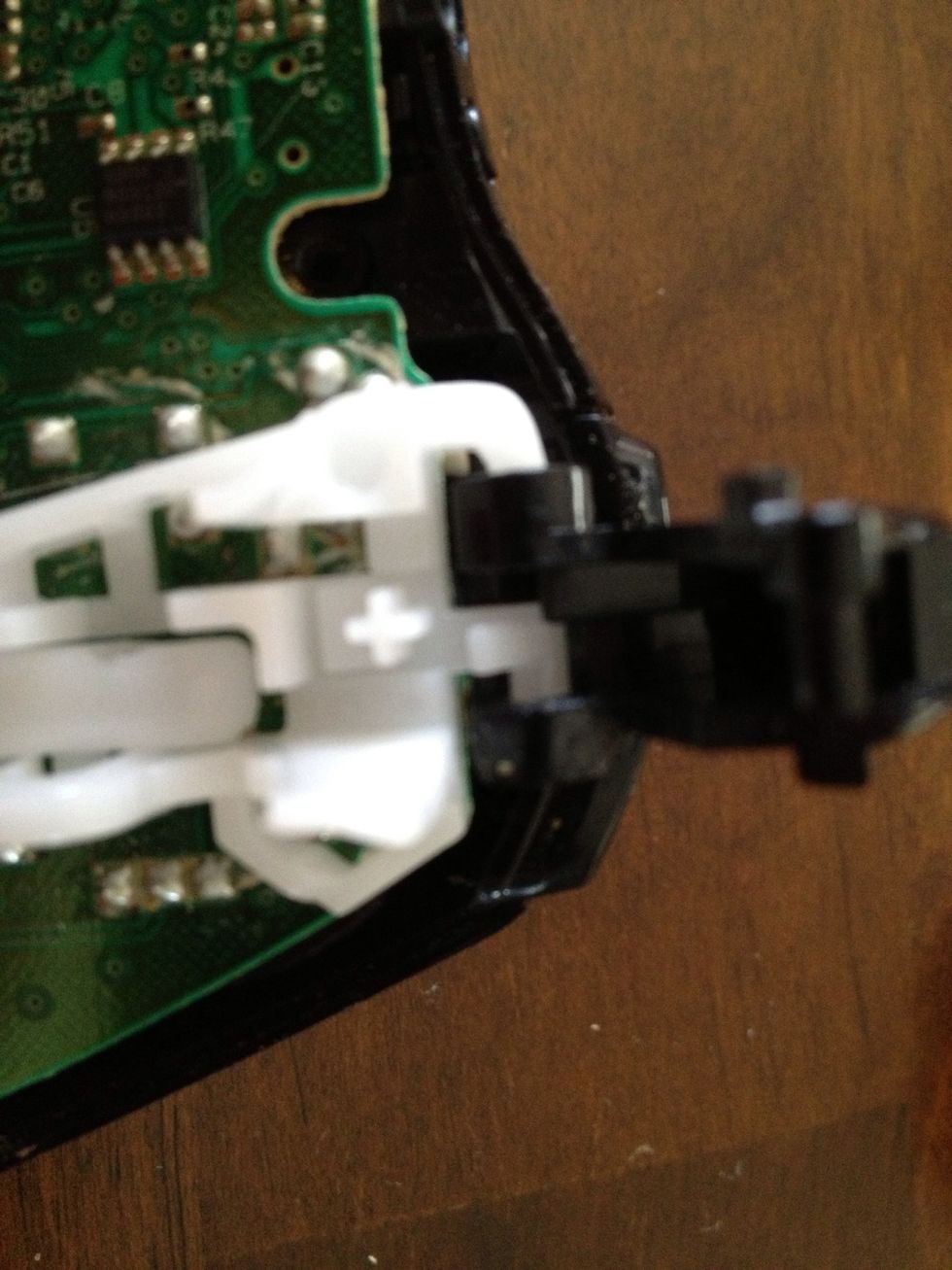 At the top of the picture where the white plastic looks kind of like a hook, the trigger needs to slide downward to come off.