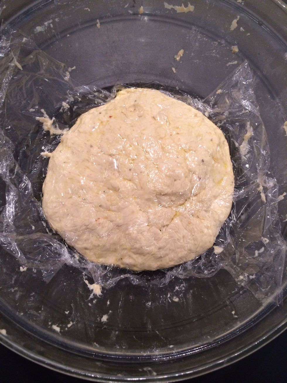 At this point I changed the bowl into a heavy glass one. The dough is so sticky the light one was sliding in all directions.  Baste with olive oil. Cover with a cling film. Leave in a warm place.