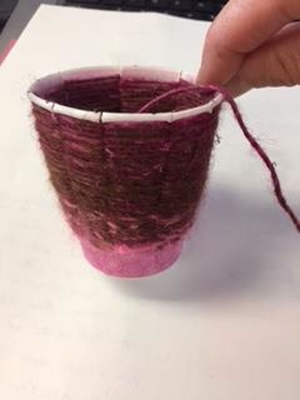At this point in your weaving, your yarn ball is still attached to your cup weaving.