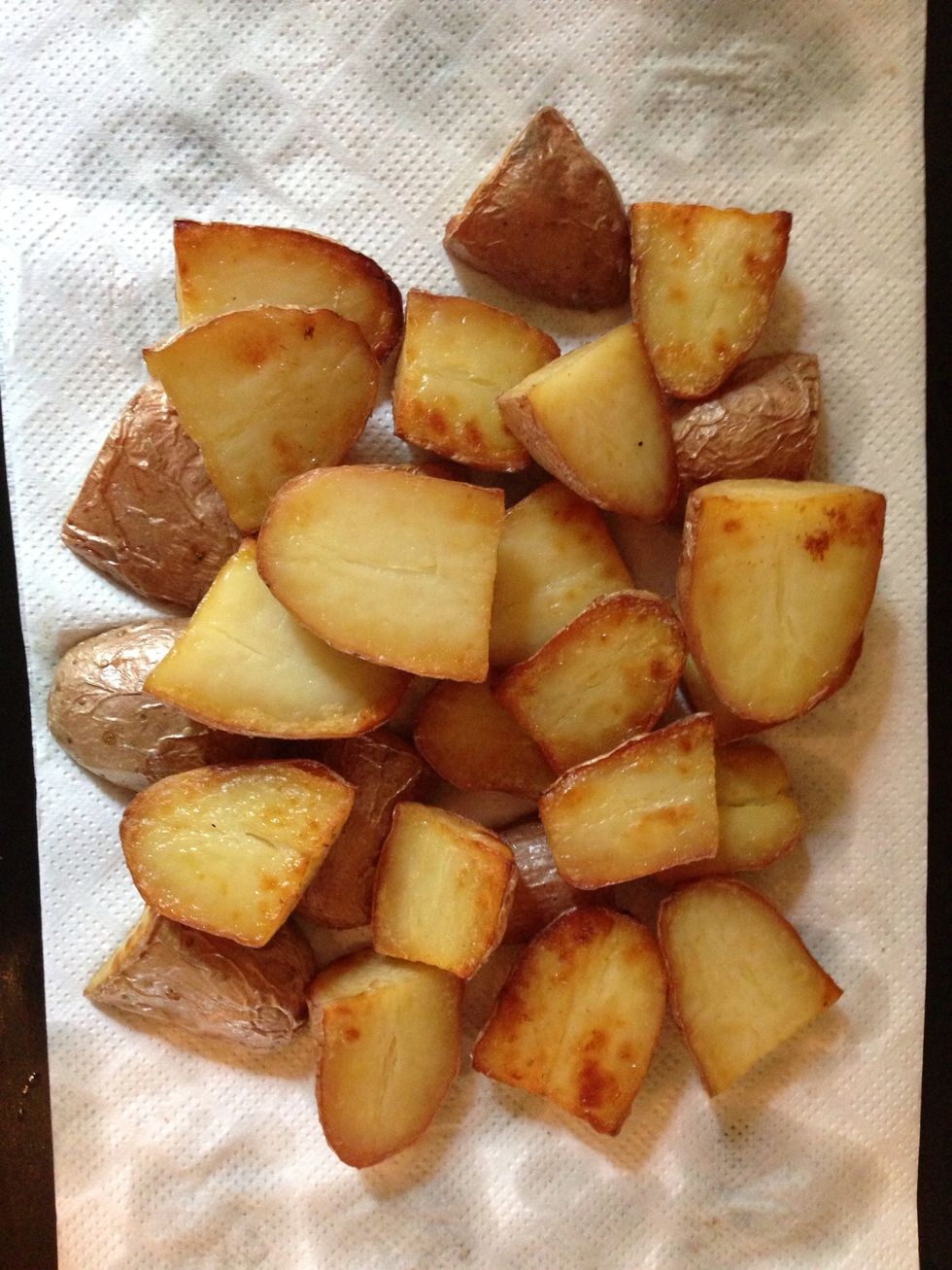 at this point you can baste the skin side of the potatoes with the butter-oil in the tray and leave them 30 more mins. out of z oven and put on kitchen paper to get rid of extra oil- butter.