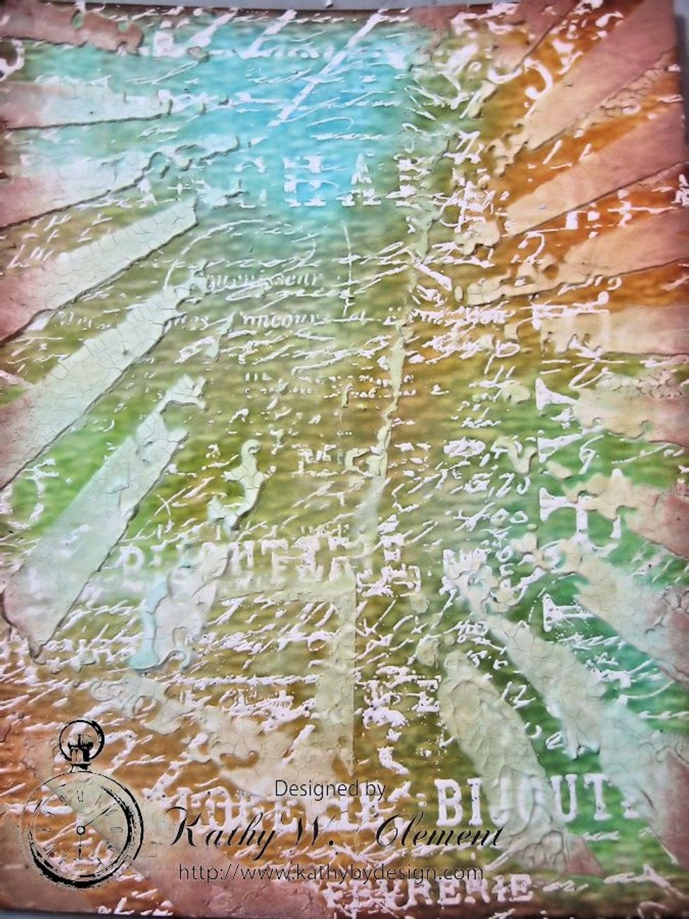 At this point, you can blend colors a little more, or spritz on more water to give individual character to each panel. I wiped ink away with a damp paper towel so the emboss resist would show better.