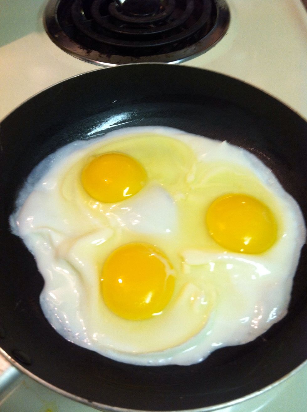 At this point you can drag the cooked whites towards the center and let the loose whites flow out and cook. I prefer this to the way I do over easy eggs because it makes them fluffier.