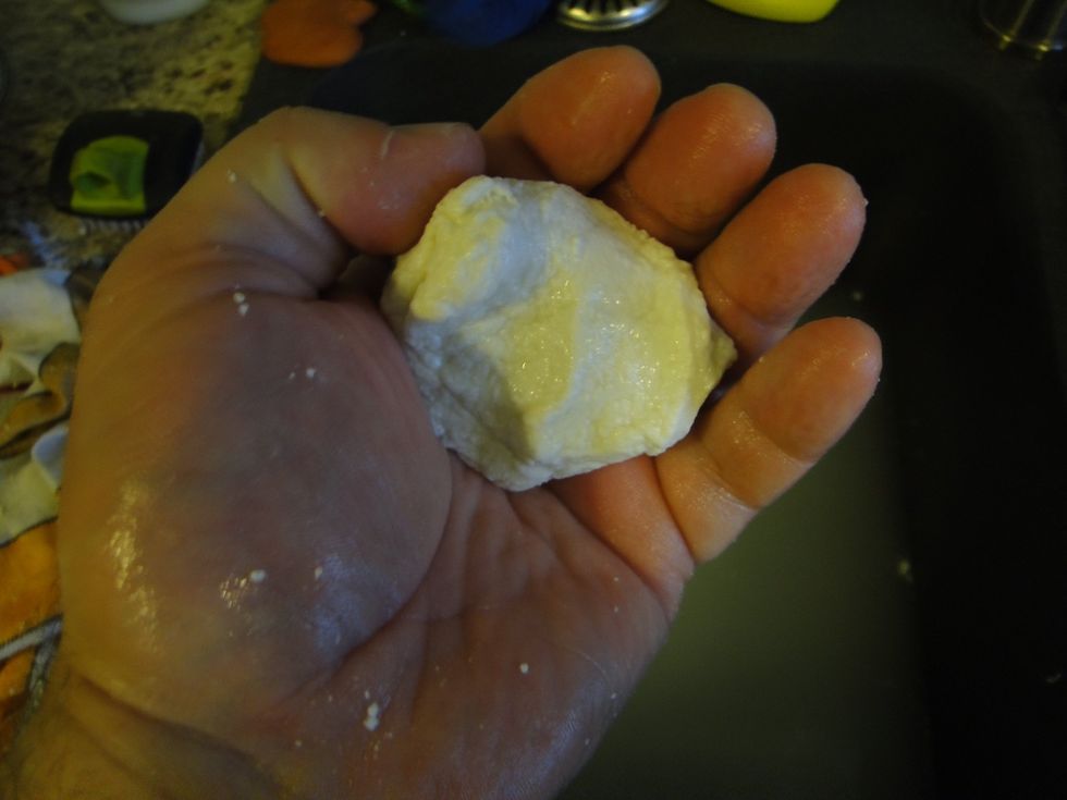 At this point you need to have tough hands, dip your hands in cold water and then knead the ball by stretching and pulling in in on itself. You will have to dip it a 2nd time in the whey .