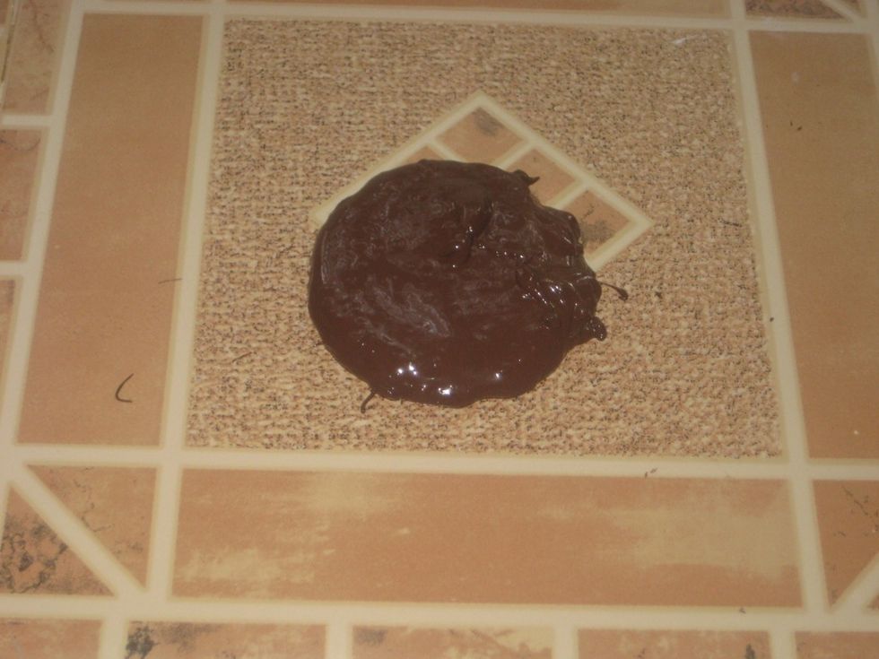 At this stage, u need a solid smooth cold surface, preferably marble. Pour the melted chocolate on the surface.