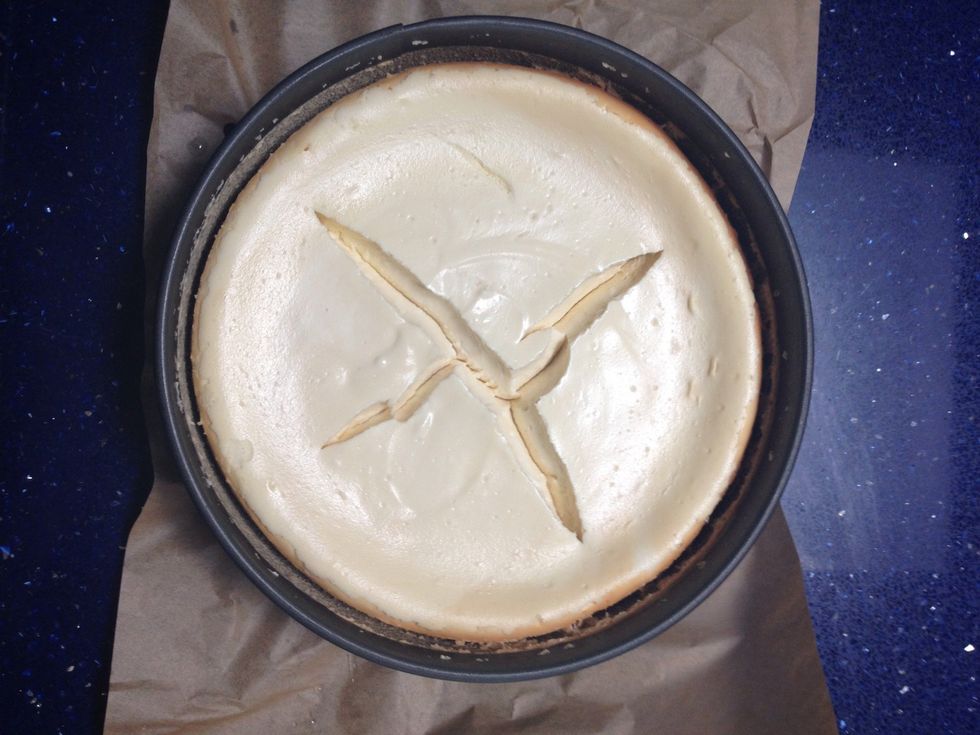 At this time, pull your cheesecake out of the fridge. Okay, so it cracked while being refrigerated\u2026 no worries! I'll show you had to fix that.