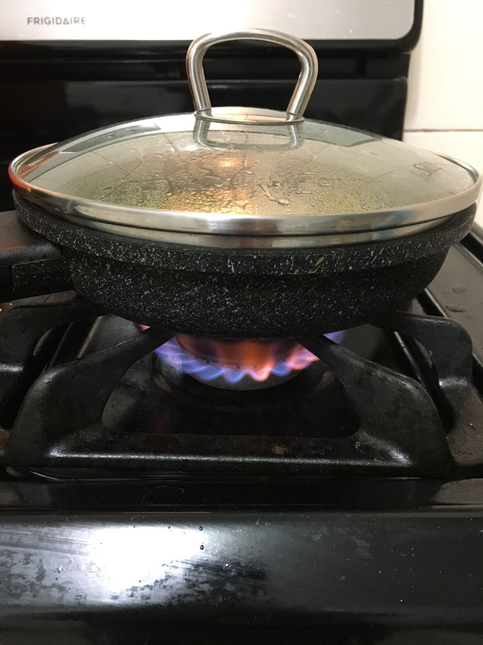 At this time you can put a lid over the pan to let it steam the batter. dont leave it too long or the water will drop in and make it all soggy. Just leave it until the batter isn't undercooked on top