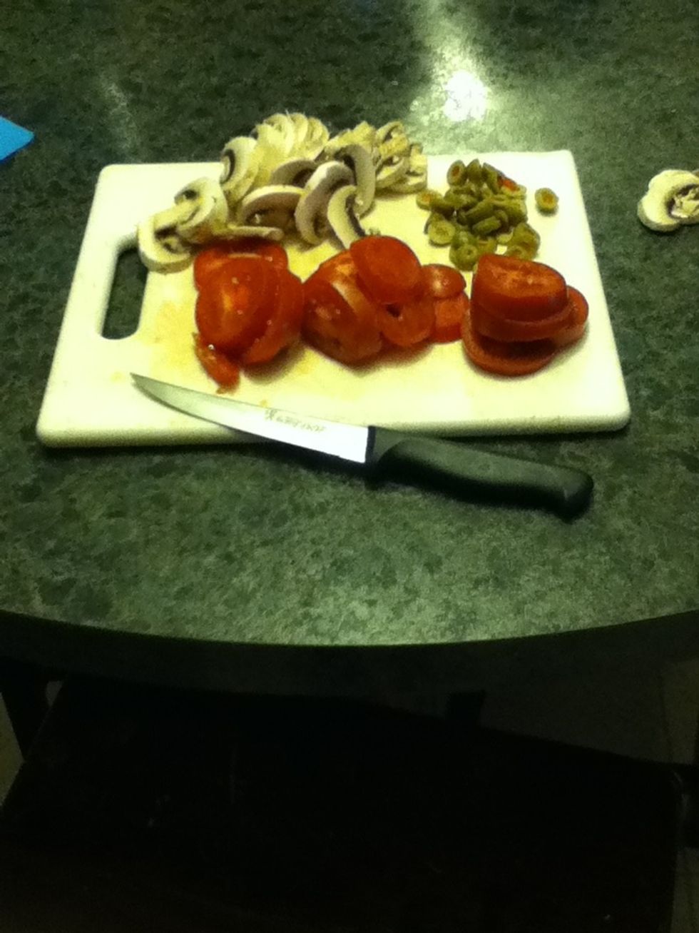 At this time, you will want To slice up whatever toppings you aspire to use on the pizza.