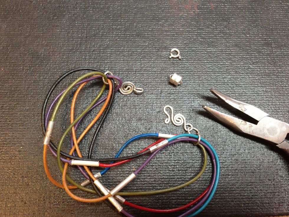 Attach a clasp to the jump rings. I've used a handmade sterling silver clasp, but there are options. Consider using a clasp from  jewelry you don't wear anymore, like the ones shown.