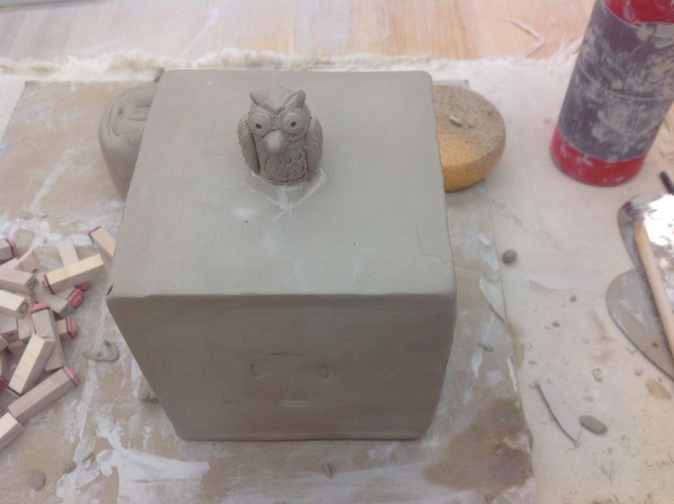 Attach a decorative topper and decorations to the sides.