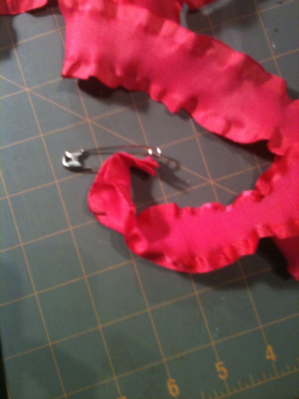 Attach a large safety pin to feed through casing.