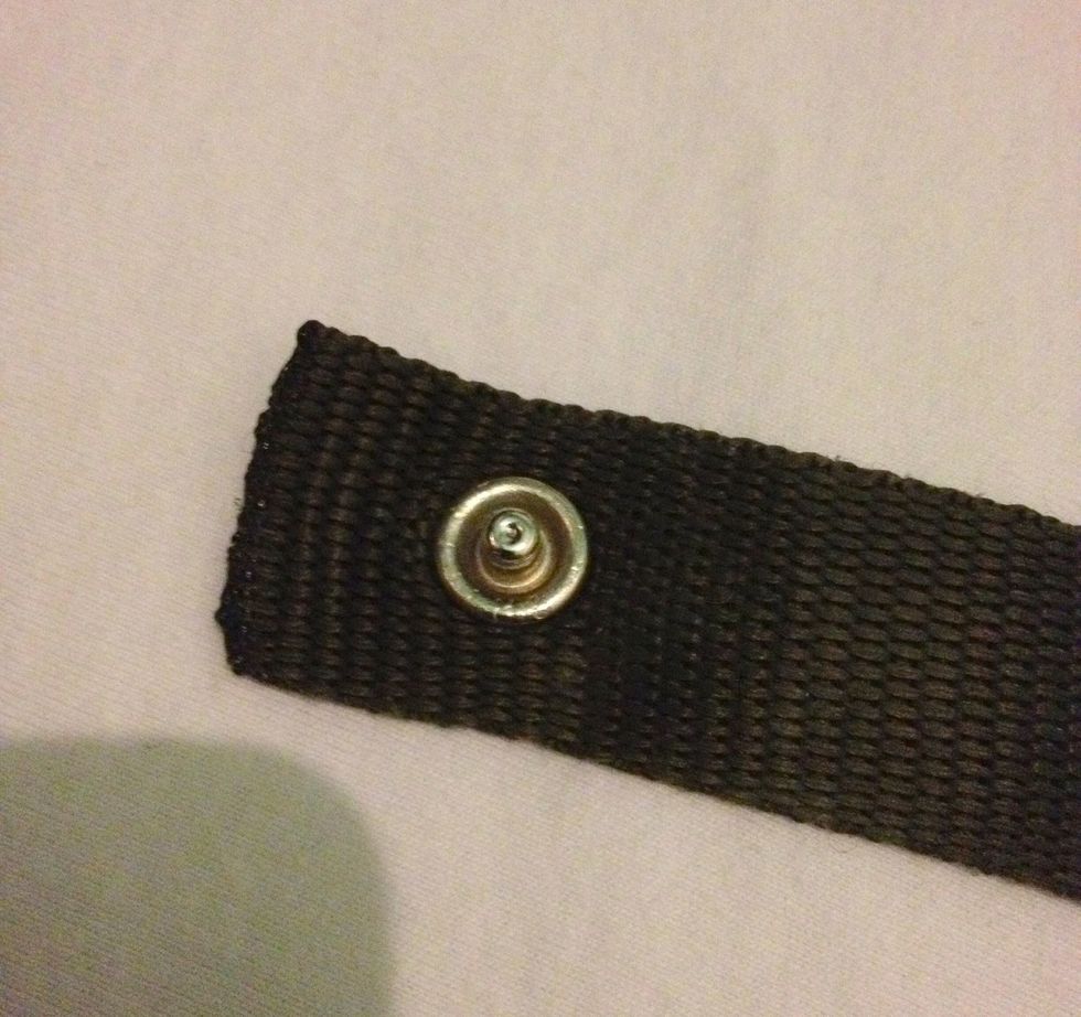 Attach a male press stud close to one end.