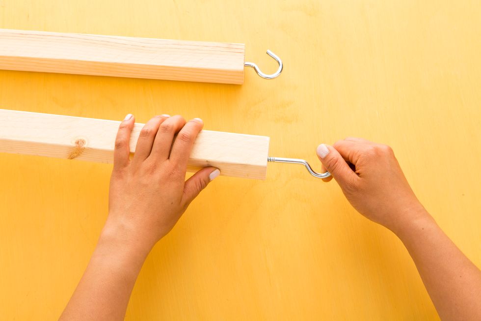 Attach a screw hook onto one end of each furring strip.