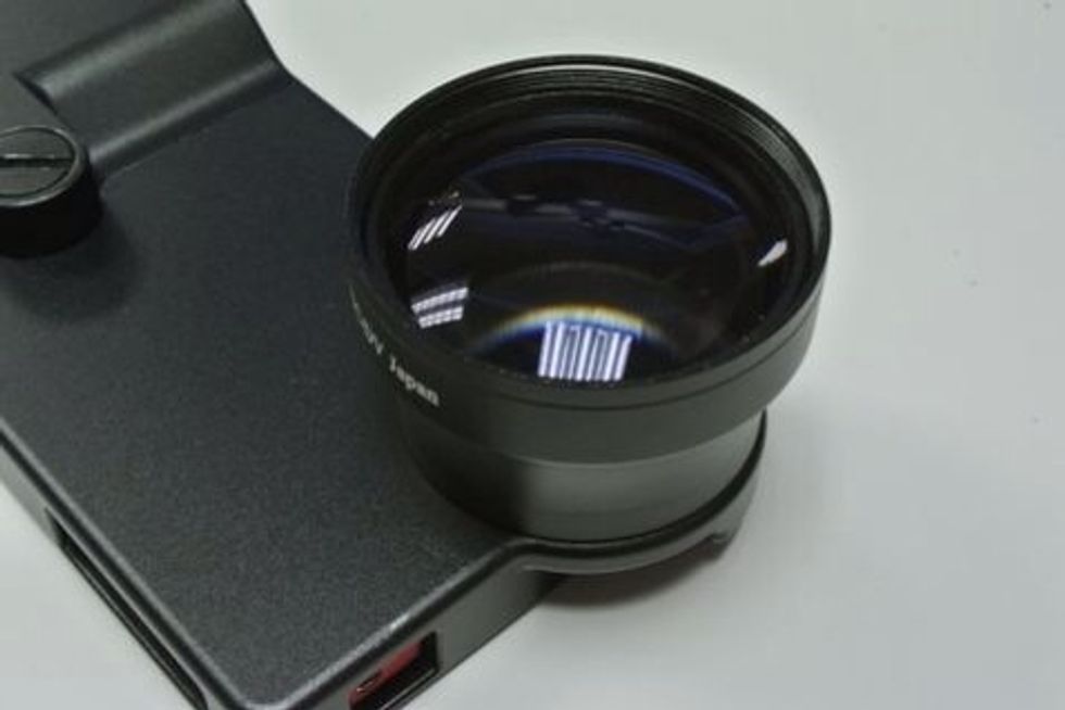 Attach a tele conversion lens.
