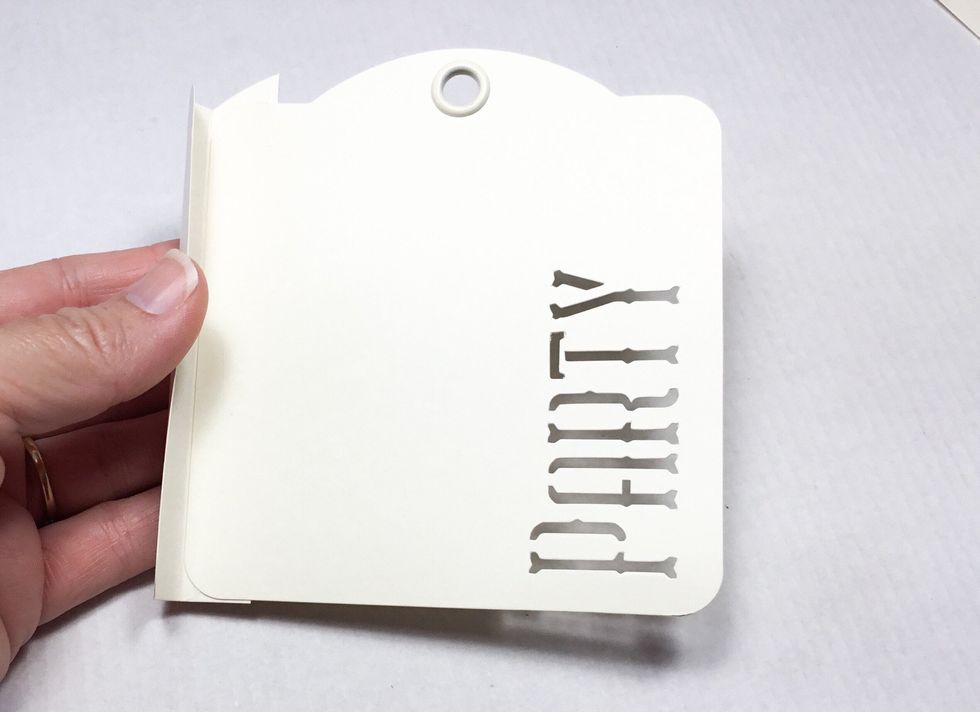 Attach back tag to the inside of the scored piece as shown.