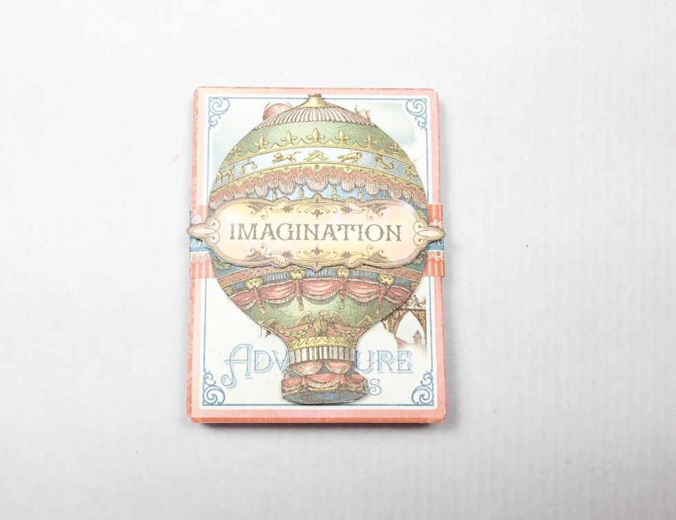 Attach balloon and title as shown to the paper band.