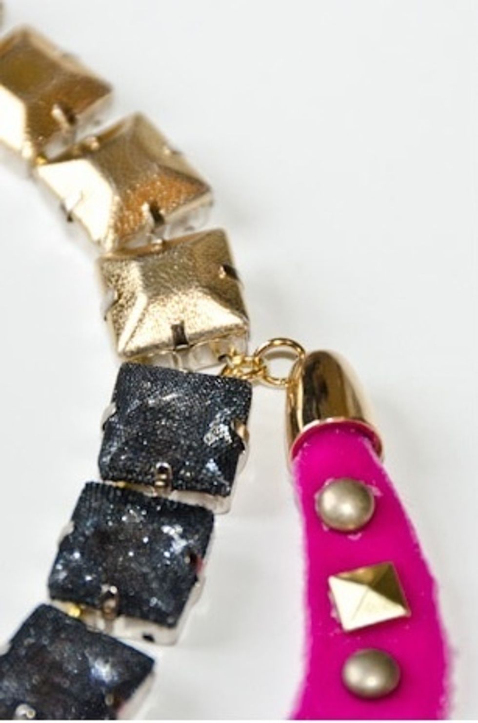 Attach both crescents to your necklace using a bit of wire or jump rings. You'll attach the top of the crescent between the gold and black beads and the base should attach to the center stone.
