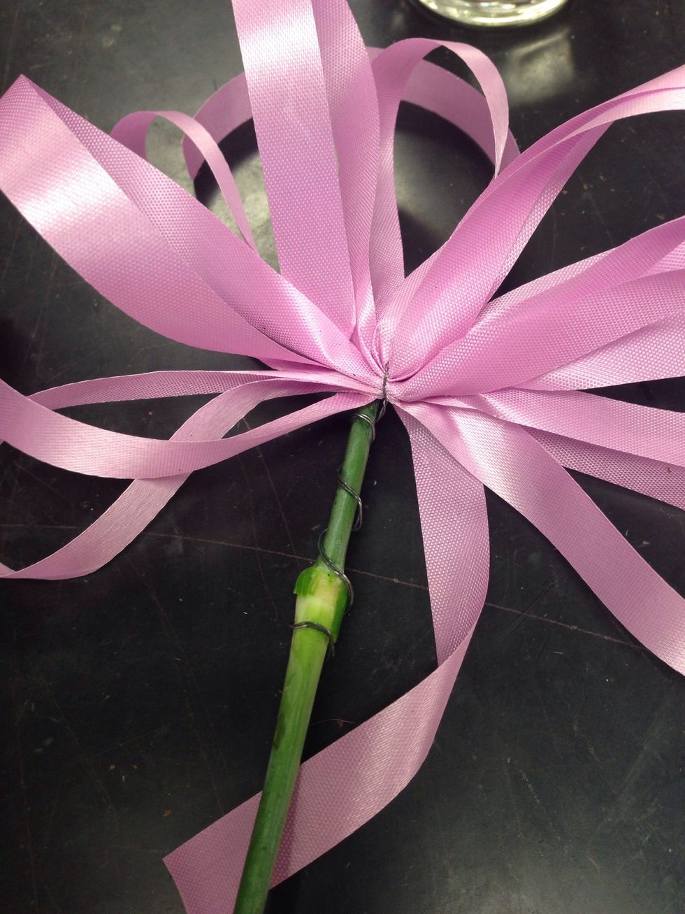 attach bow wire to a left over stem. then stick in budvase