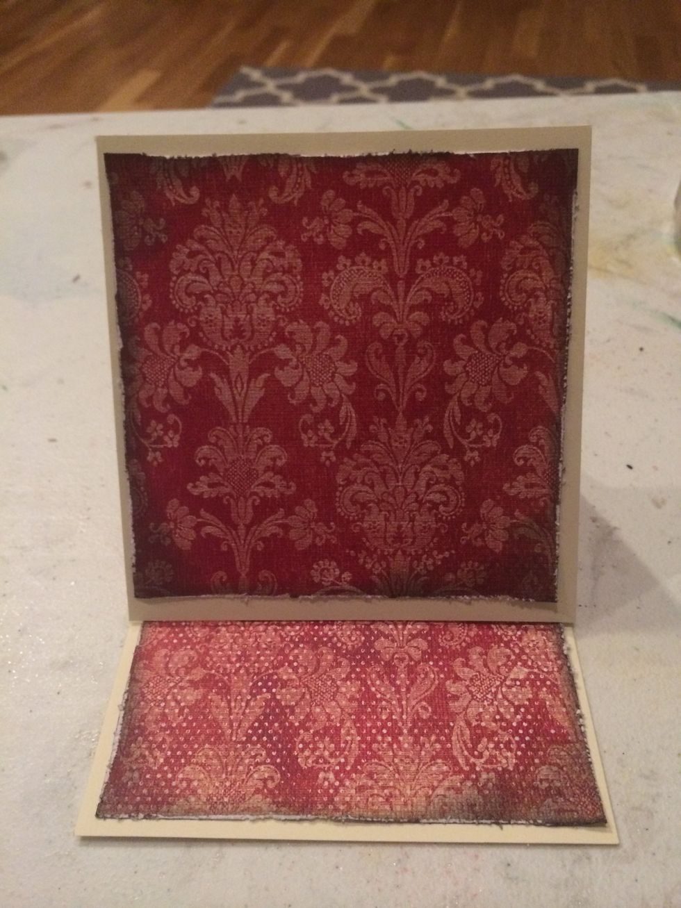 Attach cardstock to the top/front by applying tape/glue ONLY to sides and bottom. This will alow you to add a pullout tag behind the cardstock. Then attach the second piece to the base/bottom of card.