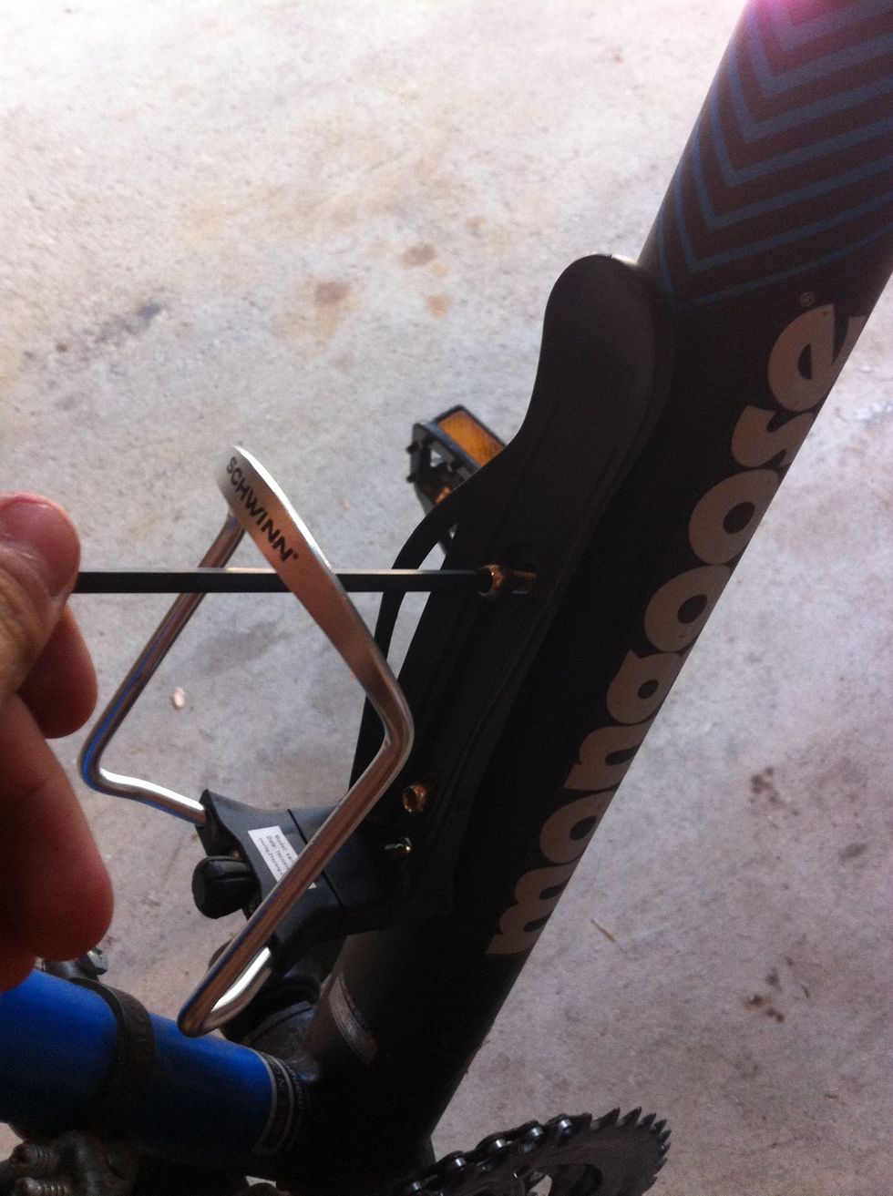 Attach chosen water bottle holder to bike frame by re-attaching hex screws to the bike. Make sure to tighten.