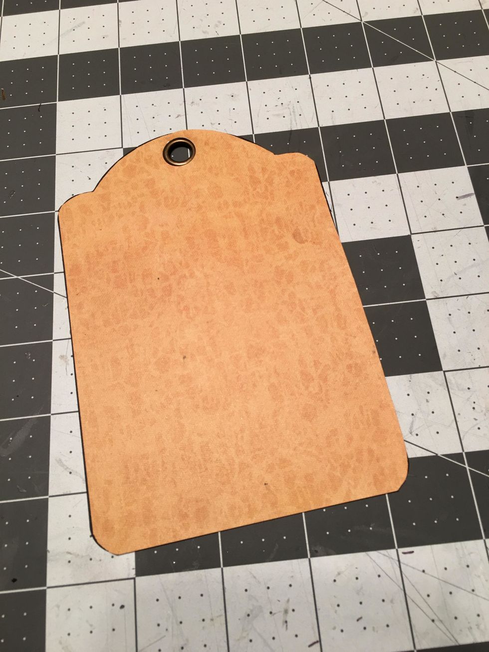 Attach down onto the tag, make sure to line it up straight and place the punched out hole over the metal grommet so it still shows and has a nice finish.