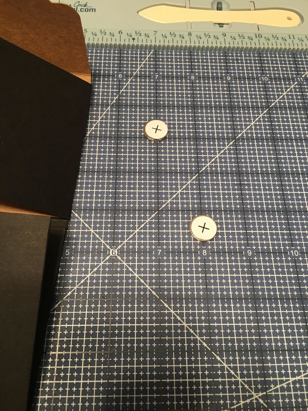 Attach each set together with the + and - paper labels to the outside. In this photo the minus side is underneath each plus magnet.