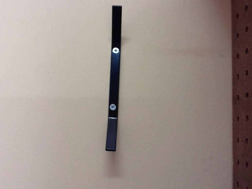 Attach excess rope holder to wall.