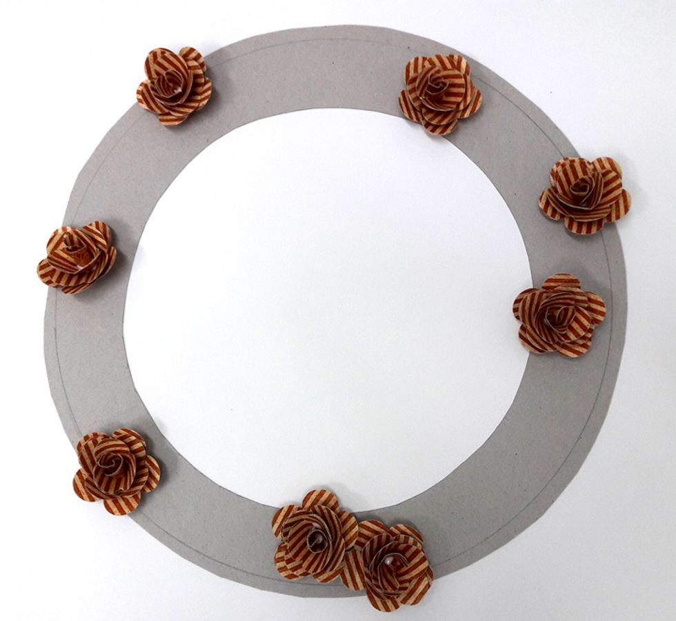 Attach flowers to chipboard circle.