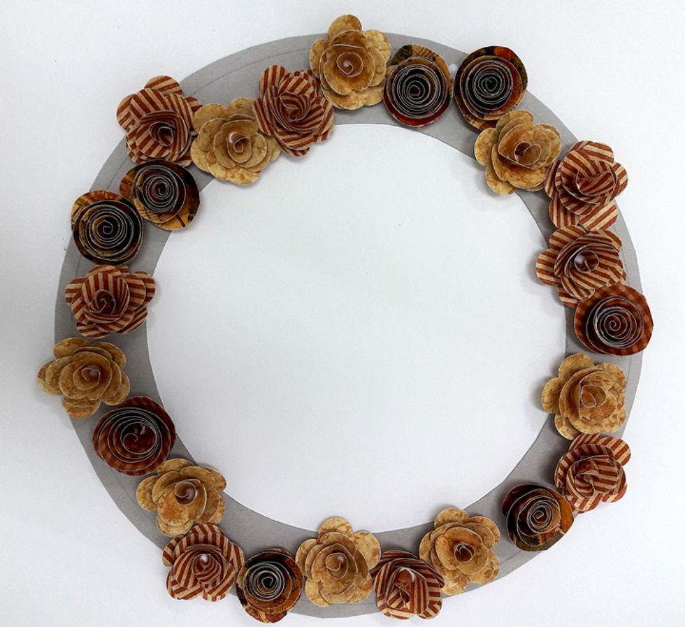 Attach flowers to chipboard circle.