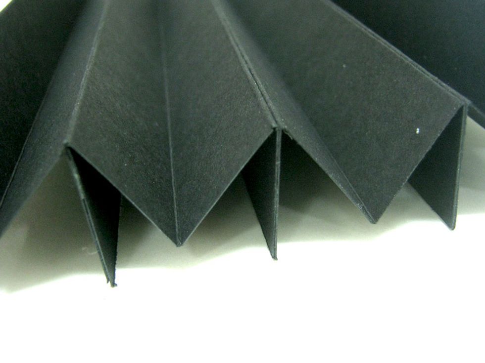 Attach four "M" shapes with tape runner. Attach another four "M" shapes together the same way. The two completed accordions will be the two sides of the tunnel book.