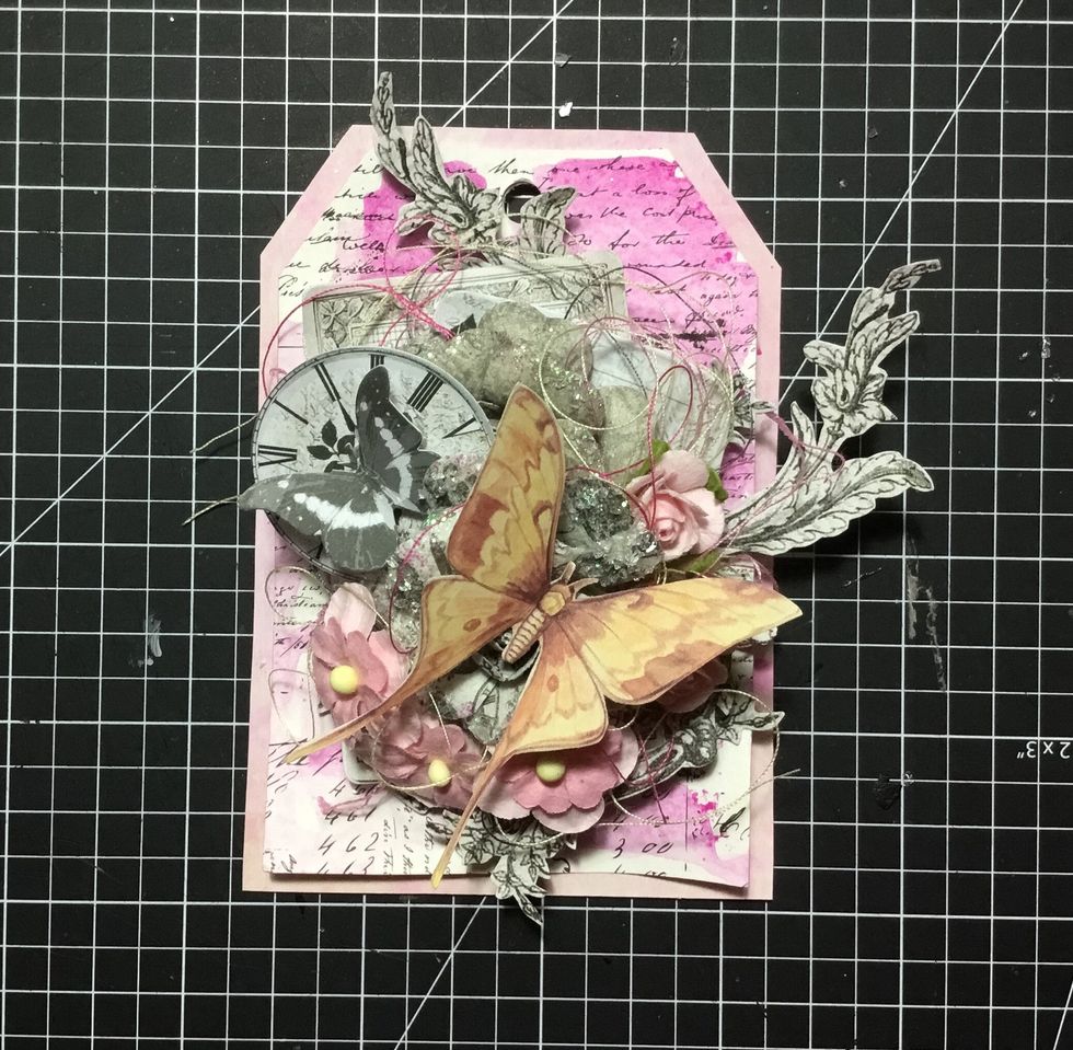 Attach fussy cut yellow butterfly as shown. Your tag is now finished!