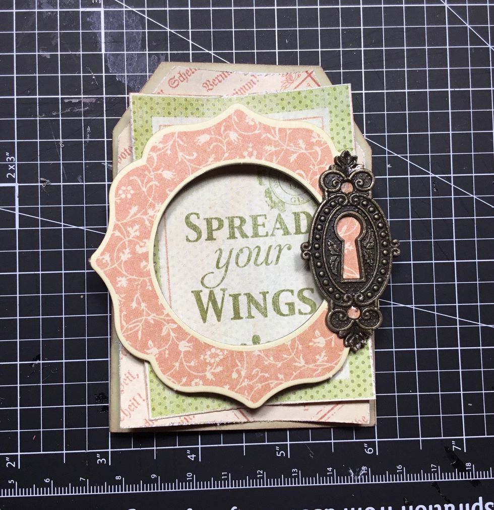 Attach Graphic 45 keyhole as shown. This will work as a weight to hold the card closed.