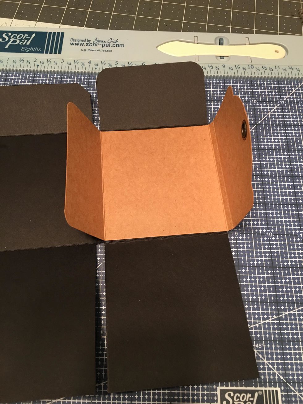 Attach it down into the inside of the album and on the right side with the grommet flap on the right.