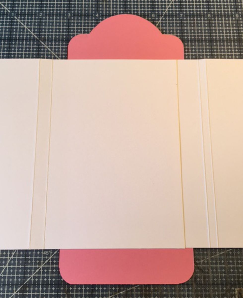 Attach left flap to tag, allowing the first fold to overhang 1/2" on left side of tag. Align with right flap.