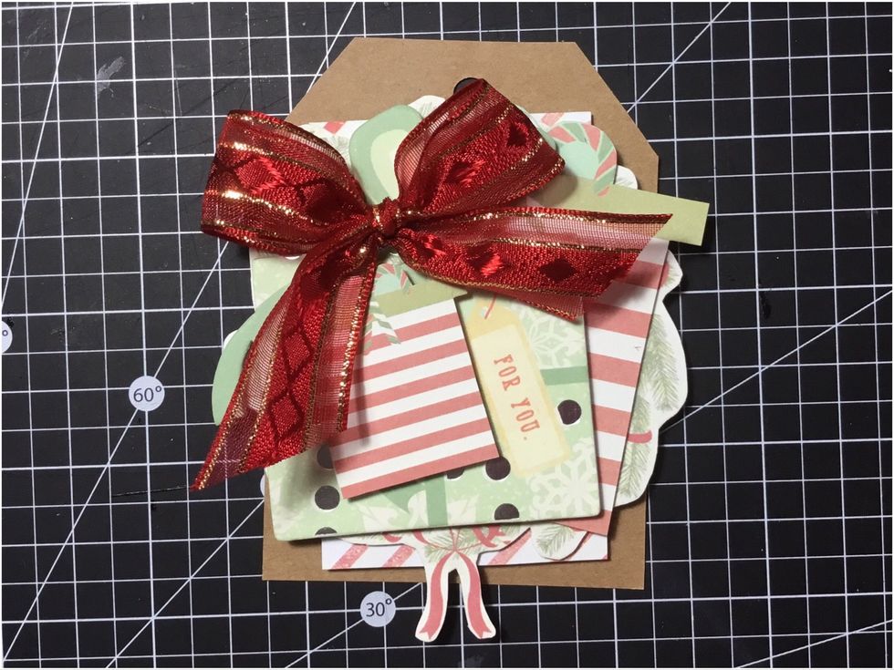 Attach medium size fussy cut present, as shown. This has also been attached with 3D dots.