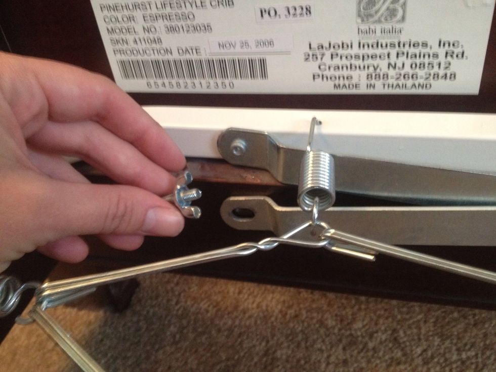 Attach metal arms to baseboards using short bolts and wing nuts.