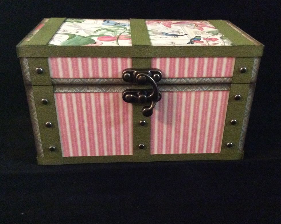 Attach metal embellishments to front of trunk. Use awl or hole piercer to allow ease if insertion of brads through chip board.