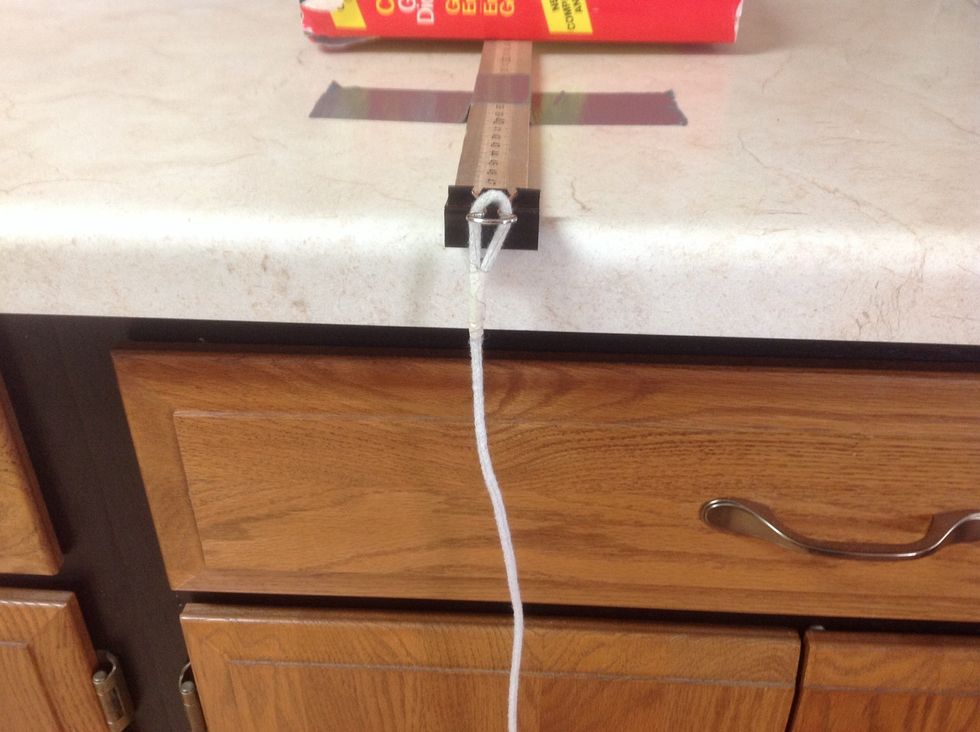 Attach one end of the looped rope to the binder clip.