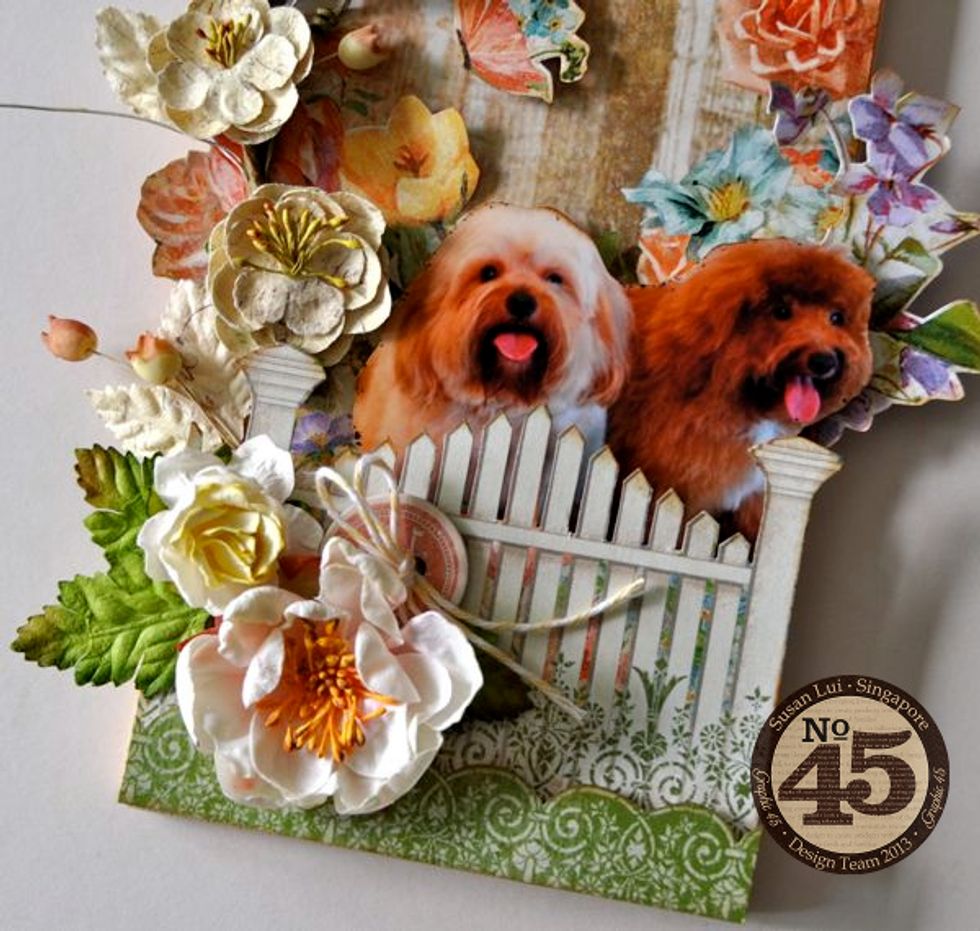 Attach some flowers, leaves and chipboards to the bottom of the cheeseboard. Add more flowers and butterflies and you're done!