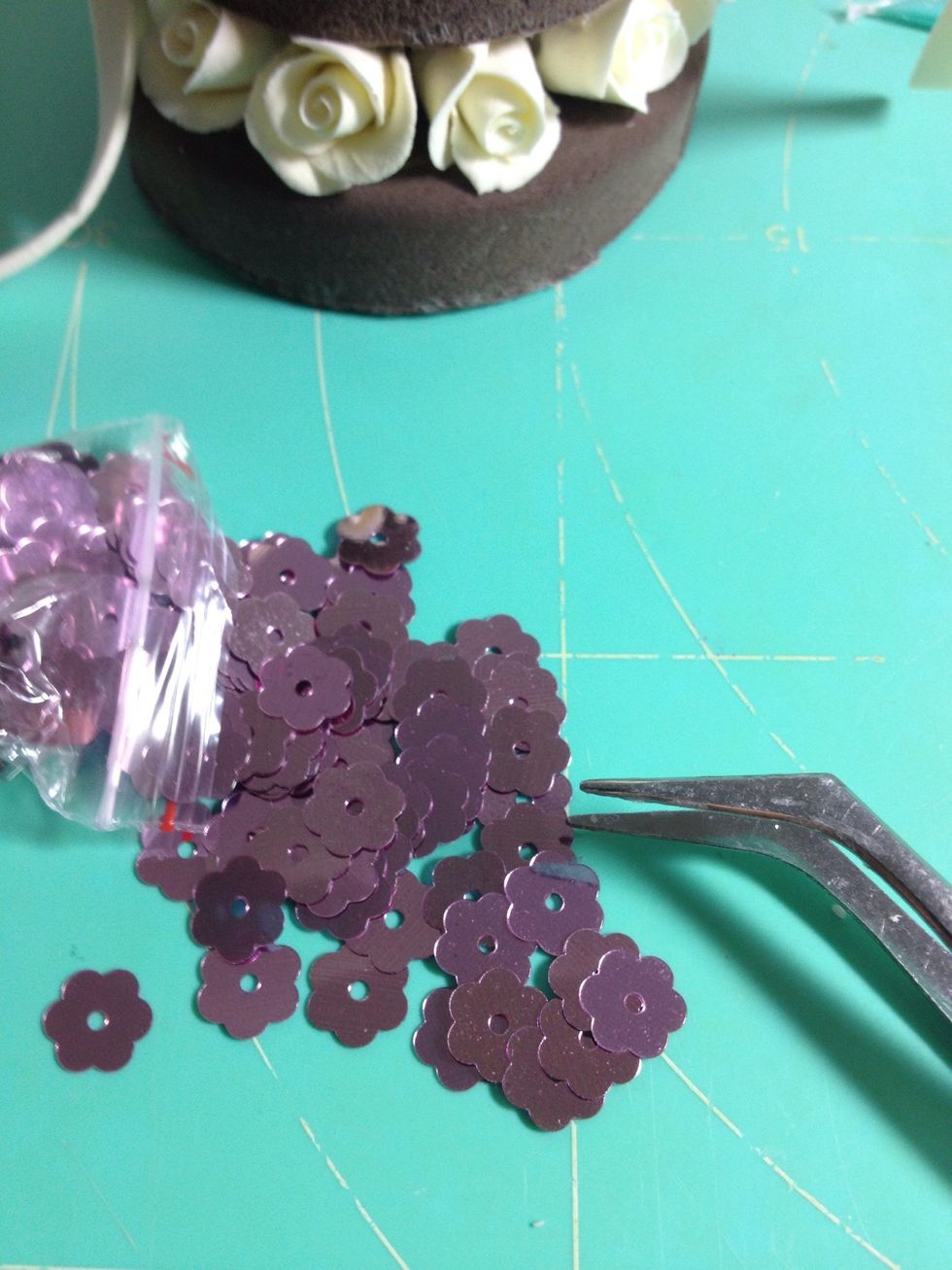 Attach some sequins on the cake for decoration. A tweezer will be helpful at this moment.