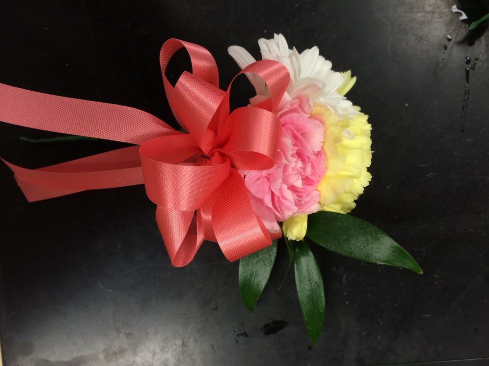 attach the bow to the flowers by taping the wire around the stems from the flowers.