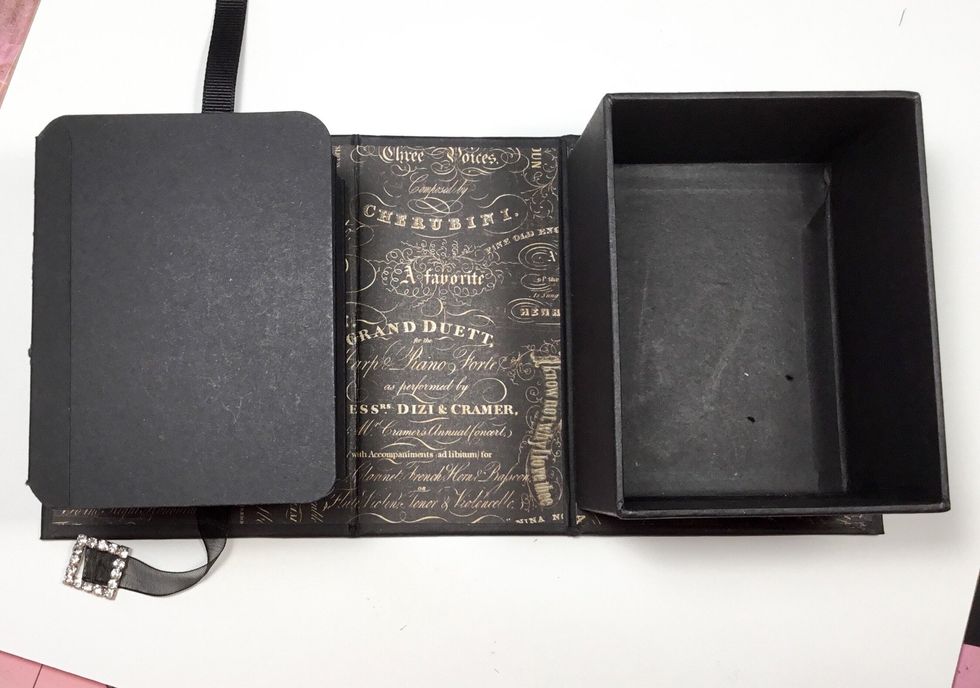 Attach the concertina album to the inside of the front cover ensuring the front page folds out. ENSURE that the album will close into the box, so placement of the album needs to be perfect.