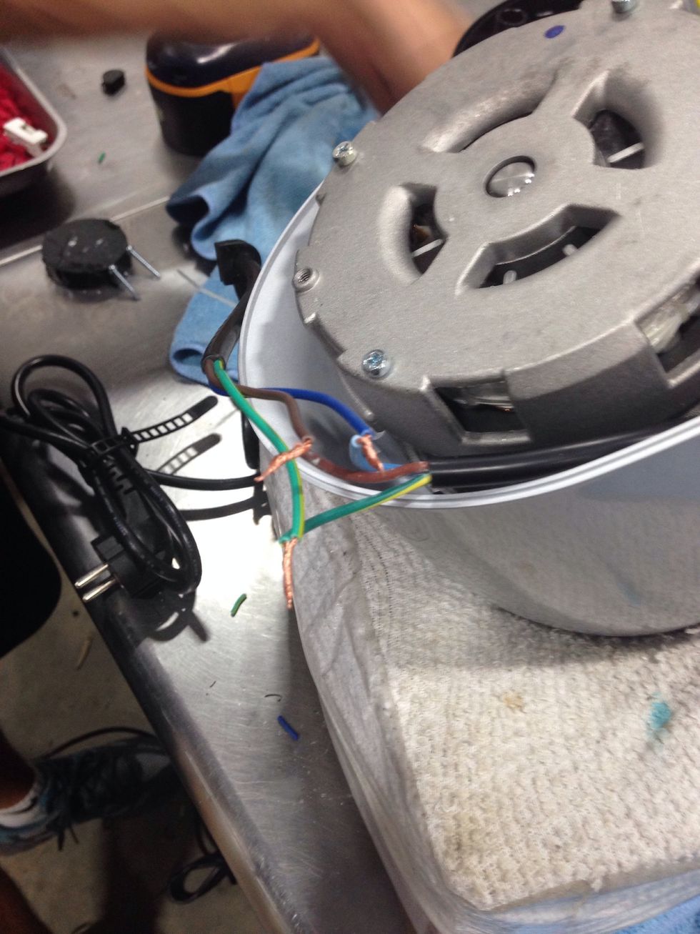 Attach the ends from the new power cord to the existing wires in the base